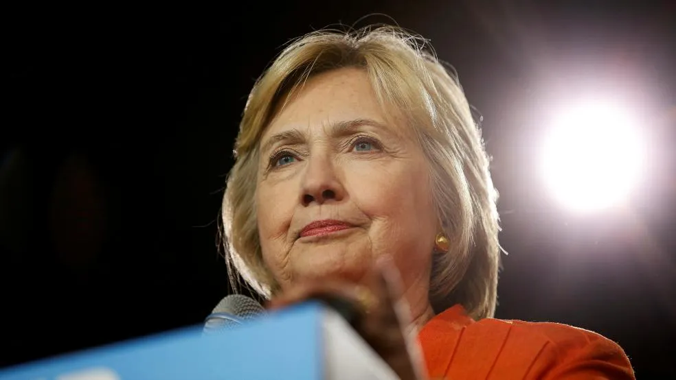 Clinton happily yields national spotlight to Trump, avoids its glare