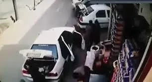 له شدن زن و شوهر زیر خودرو +فیلم